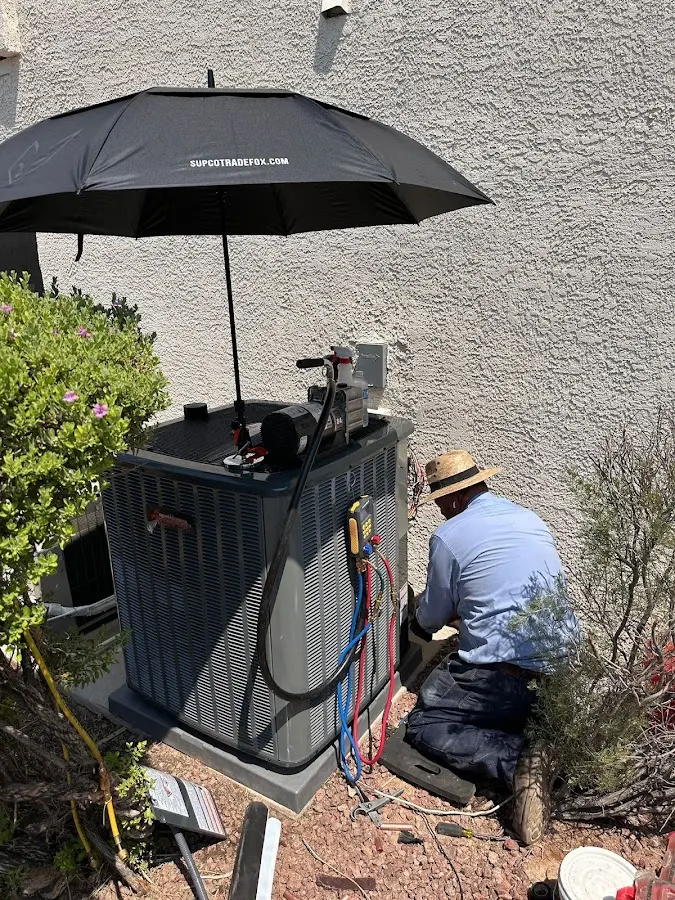 HVAC technician performing outdoor AC maintenance in Island Park